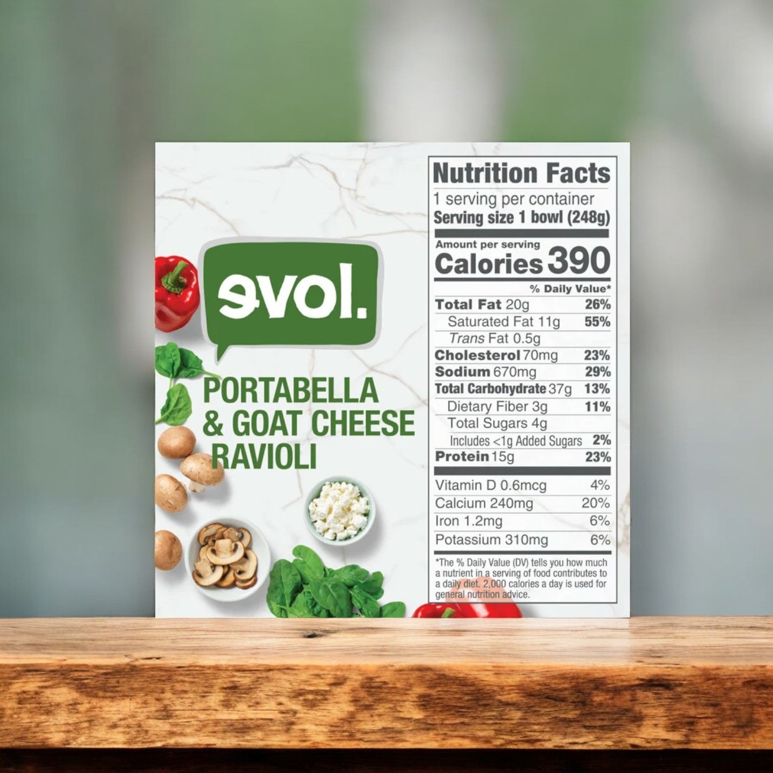 A box of Evol Portabella & Goat Cheese Ravioli, 8.75 oz. - 1 Count by Evol is displayed, featuring the product name, an image highlighting the ravioli ingredients, and a Nutrition Facts label indicating a serving size of 1 bowl with 390 calories. This delectable vegetarian ravioli promises a flavorful meal.