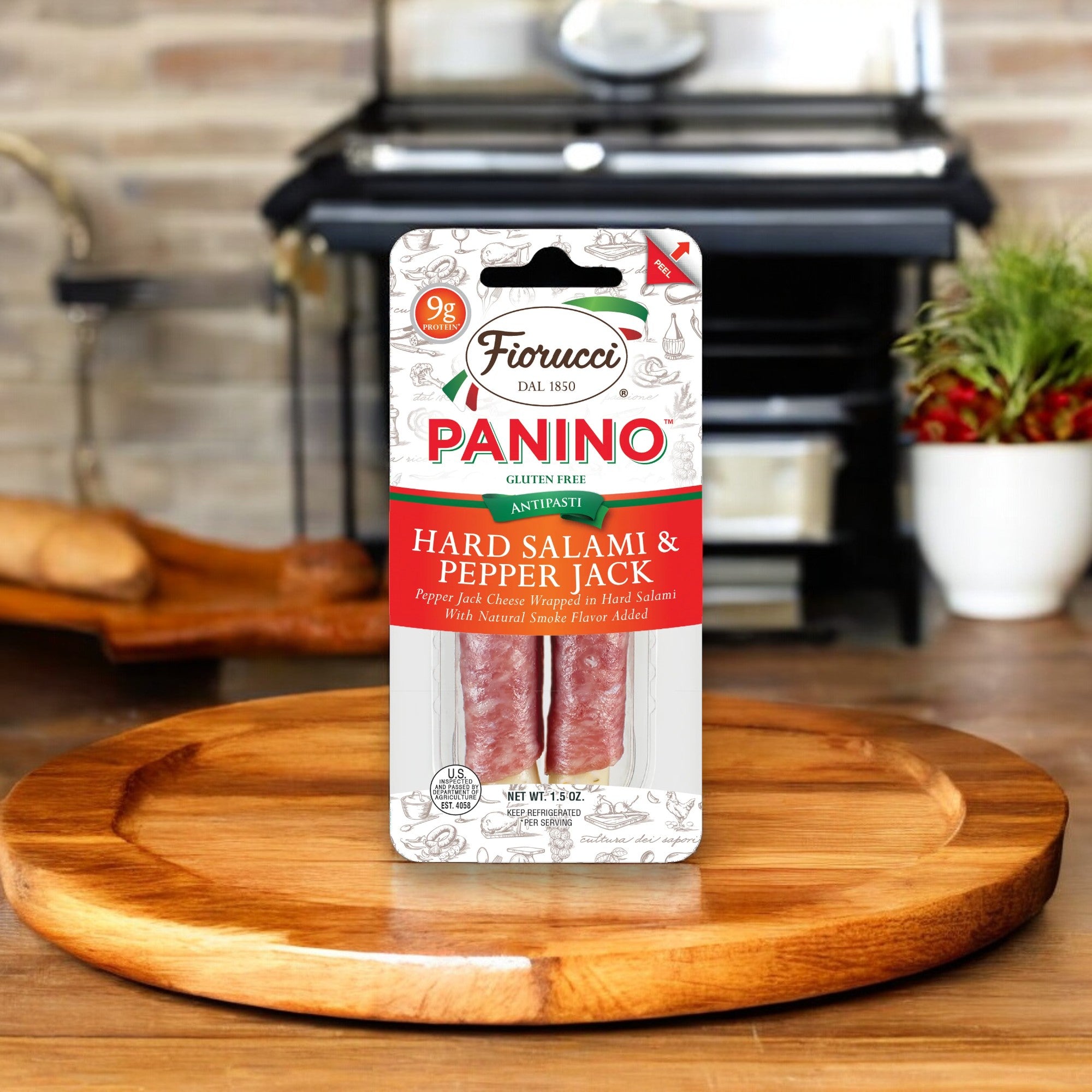 A single 1.5 oz pack of Fiorucci Panino Hard Salami & Pepper Jack Cheese, both gluten-free, sits on a wooden cutting board with a kitchen background.