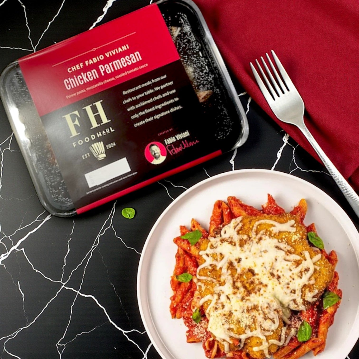FoodHaul Frozen Meals – Signature Chef Meal Combo – 5 Gourmet Entrées is served beside a plate of chicken parmesan with pasta, garnished with cheese and basil, bringing signature restaurant-quality meals to your table.