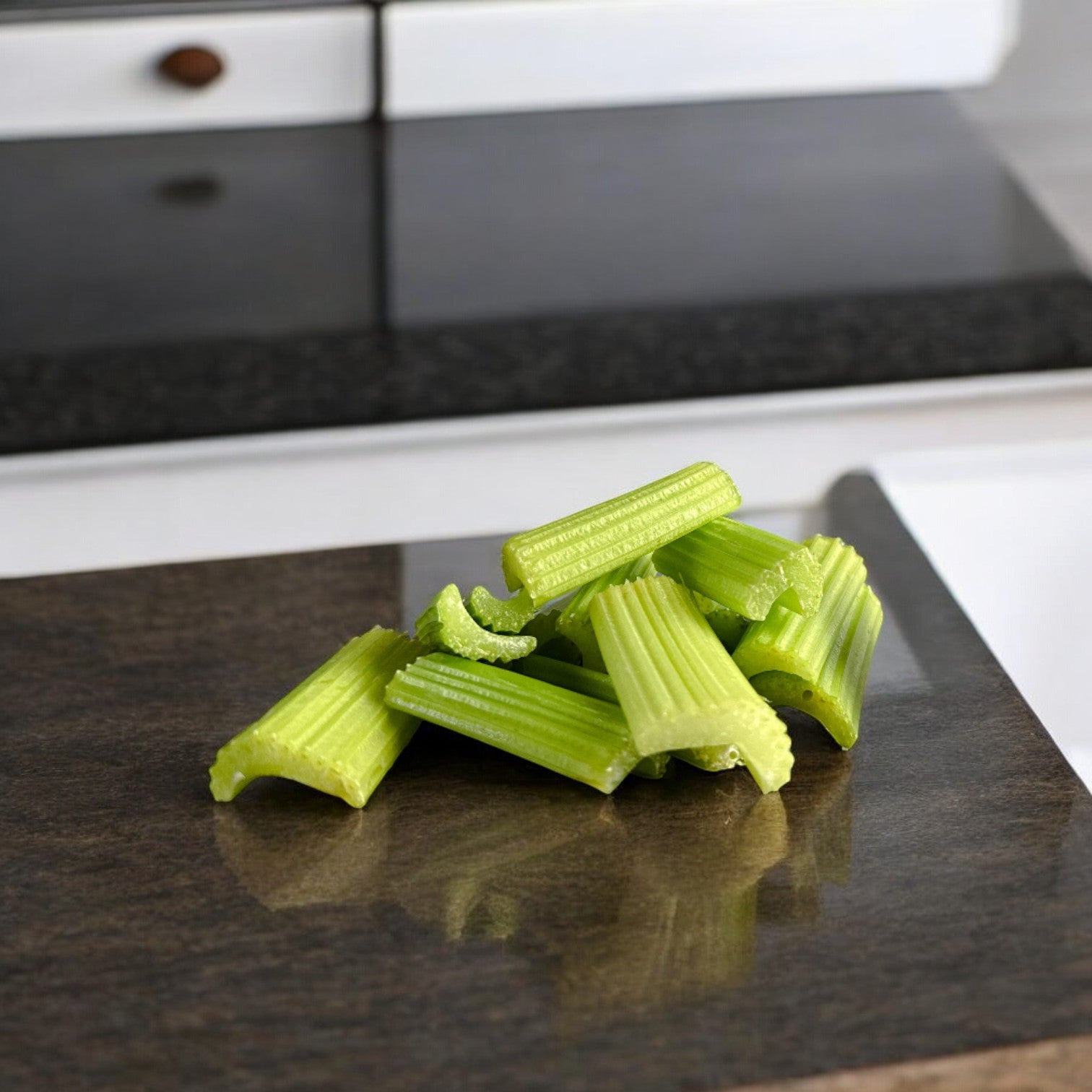 Celery Fresh Sliced 1.6 oz pack - 1 Count by Easy Lunches, neatly arranged, rest on a dark granite countertop in a kitchen setting.