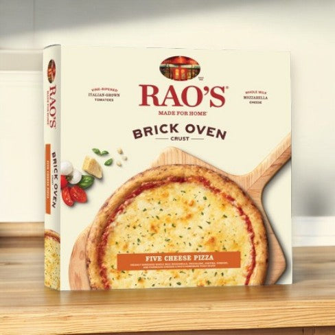 A box from the Easy Lunches Rao's Pizza Bundle - featuring an image of their Brick Oven Crust Five Cheese Pizza topped with herbs and cheeses on a wooden board, displayed on a kitchen countertop. The bundle includes 1 Meat Trio Pizza and 1 Five Cheese Pizza, totaling 2 pizzas.