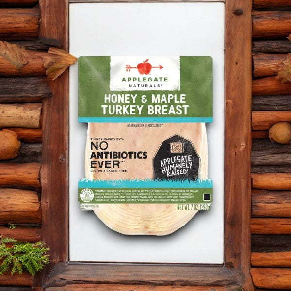 Package of Applegate Natural Honey & Maple Turkey Breast, 7 oz- 1 Count, labeled "No Antibiotics Ever" with a rustic wooden background, showcasing its dedication to natural ingredients.