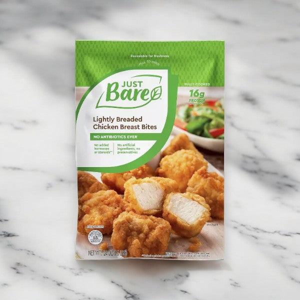 A package of Just Bare NAE Lightly Breaded Chicken Breast Original Bites - 4 lbs - 1 Count, featuring the brand's front label with images of the chicken bites and salad in the background, highlighting all-natural ingredients and no antibiotics ever.