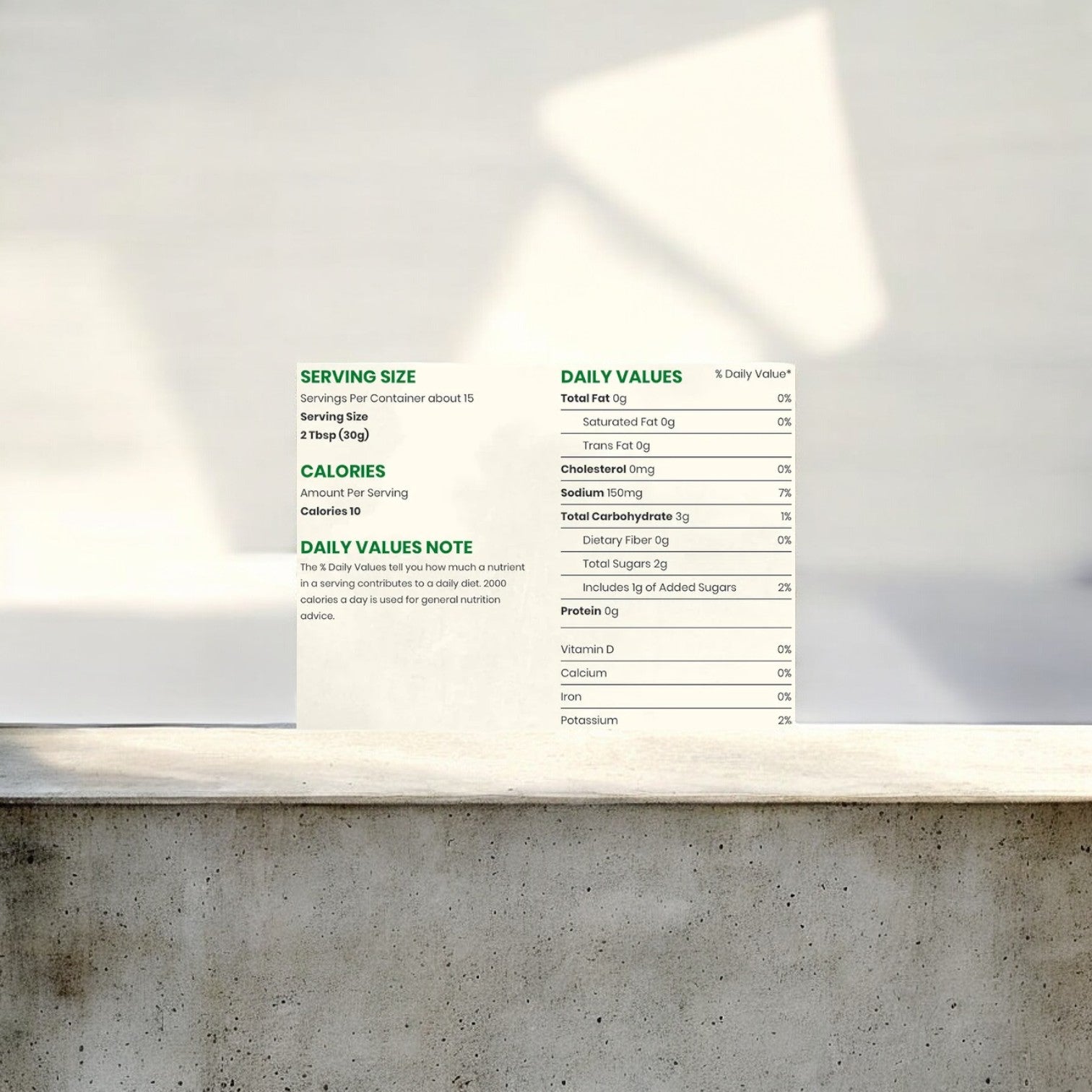 Close-up of a nutrition facts label on a concrete surface, detailing serving size, calories, and daily value percentages for total fat, cholesterol, sodium, and other nutrients on Easy Lunches Garden Fresh Gourmet Jack's Special Medium Salsa. Bright, blurred background.