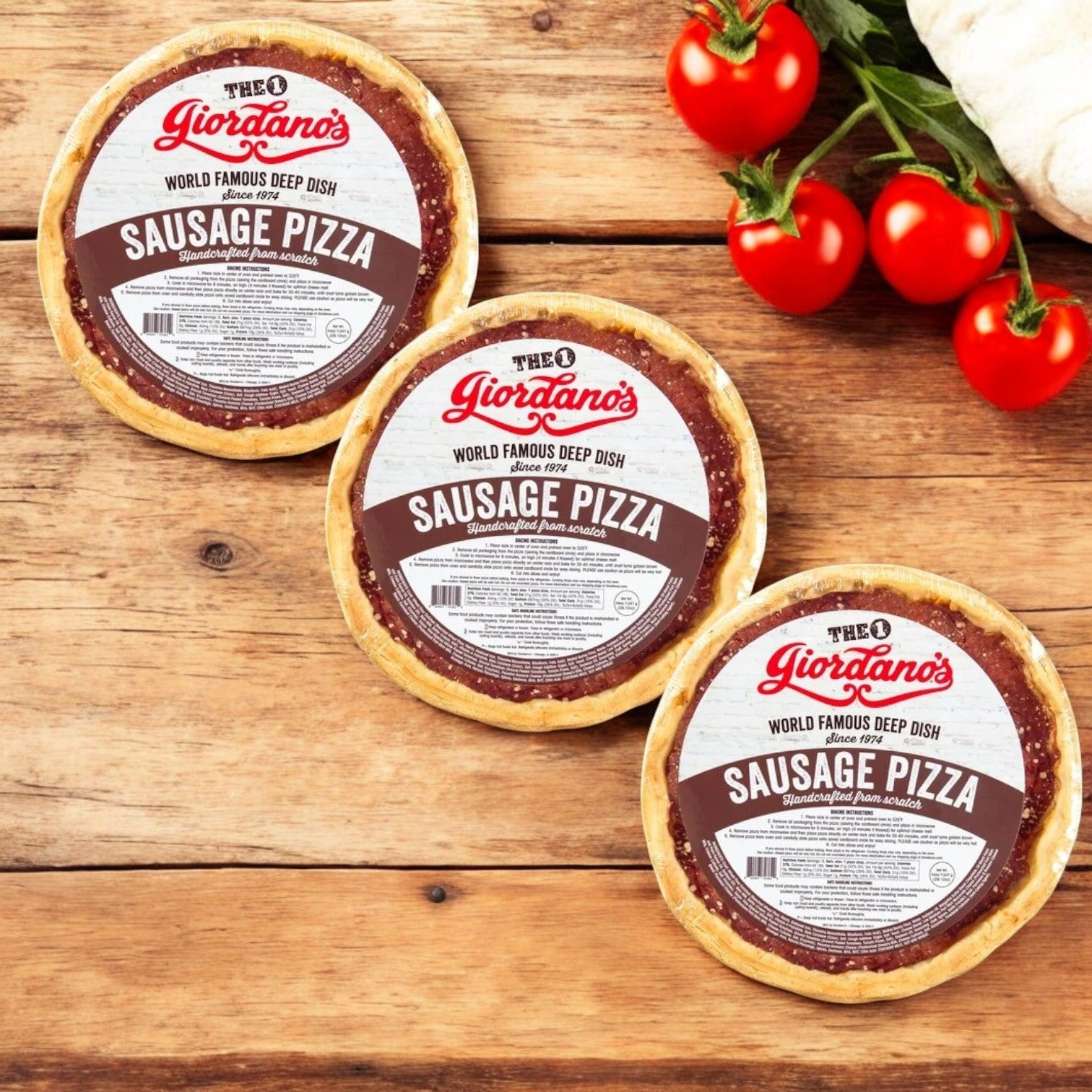 Three packs of Giordano's Frozen Deep Dish Stuffed Sausage Pizza, 10", sit on wood next to vine tomatoes and dough, delivering authentic Chicago deep dish flavors in every bite.