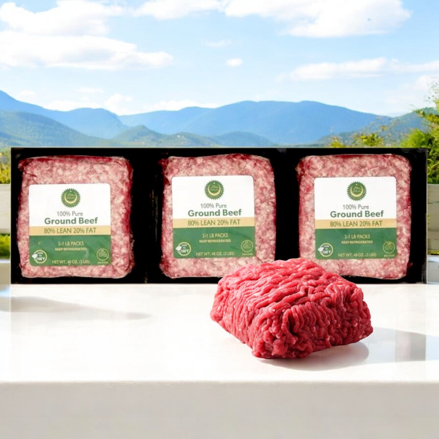 Three packages of Crescent Foods' Halal Ground Beef, 80% lean and 20% fat, rest on a table with majestic mountains in the background. A portion of unwrapped ground beef is in front, showcasing the rich texture of this 3 lb blend.