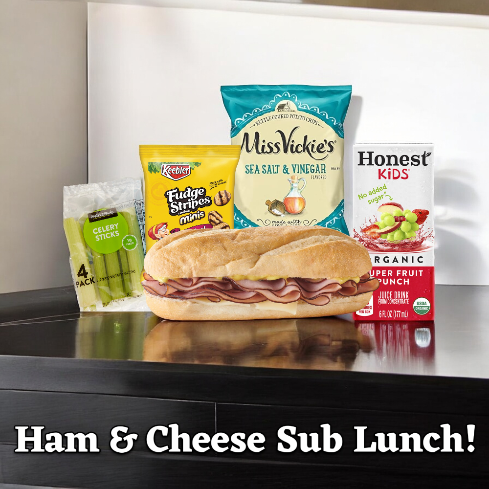 On a table sits a Ham & Cheese Sub Lunch! featuring 1 Smoked White Turkey & Provolone Cheese Sub, celery sticks, a bag of Miss Vickie's Salt & Vinegar Chips, mini fudge stripe cookies, and an Honest Kids Fruit Punch juice box. Text reads "Ham & Cheese Sub Lunch!" from Easy Lunches.