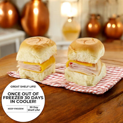 On a wooden table sit two Smoked White Turkey and Cheddar Sliders by E.A. Sween, with a label indicating a 30-day shelf life and offering freezer storage guidance.