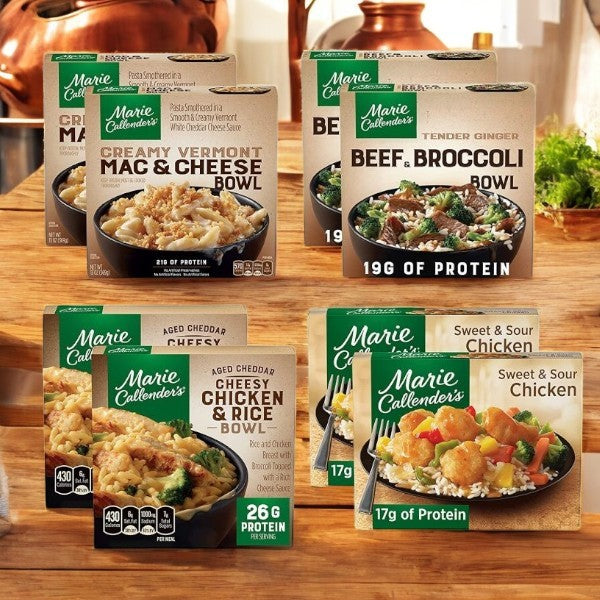 The Marie Callender Meals Bundle includes 8 assorted meals like mac & cheese and beef & broccoli, made with quality ingredients. Perfect for quick meals or grabbing from the Party Pack for any occasion, these are displayed beautifully on a wooden surface.