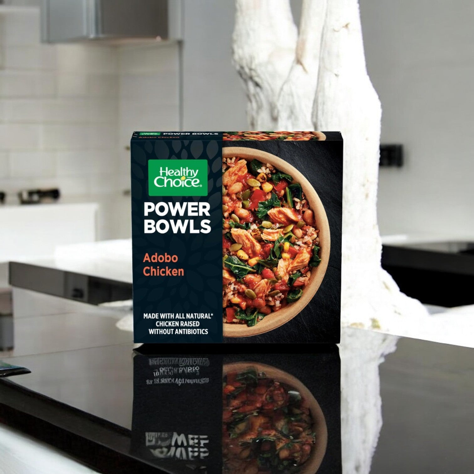 A box of Healthy Choice Power Bowls Adobo Chicken, from the Healthy Choice Power Bowl Variety Pack, placed on a modern kitchen countertop.