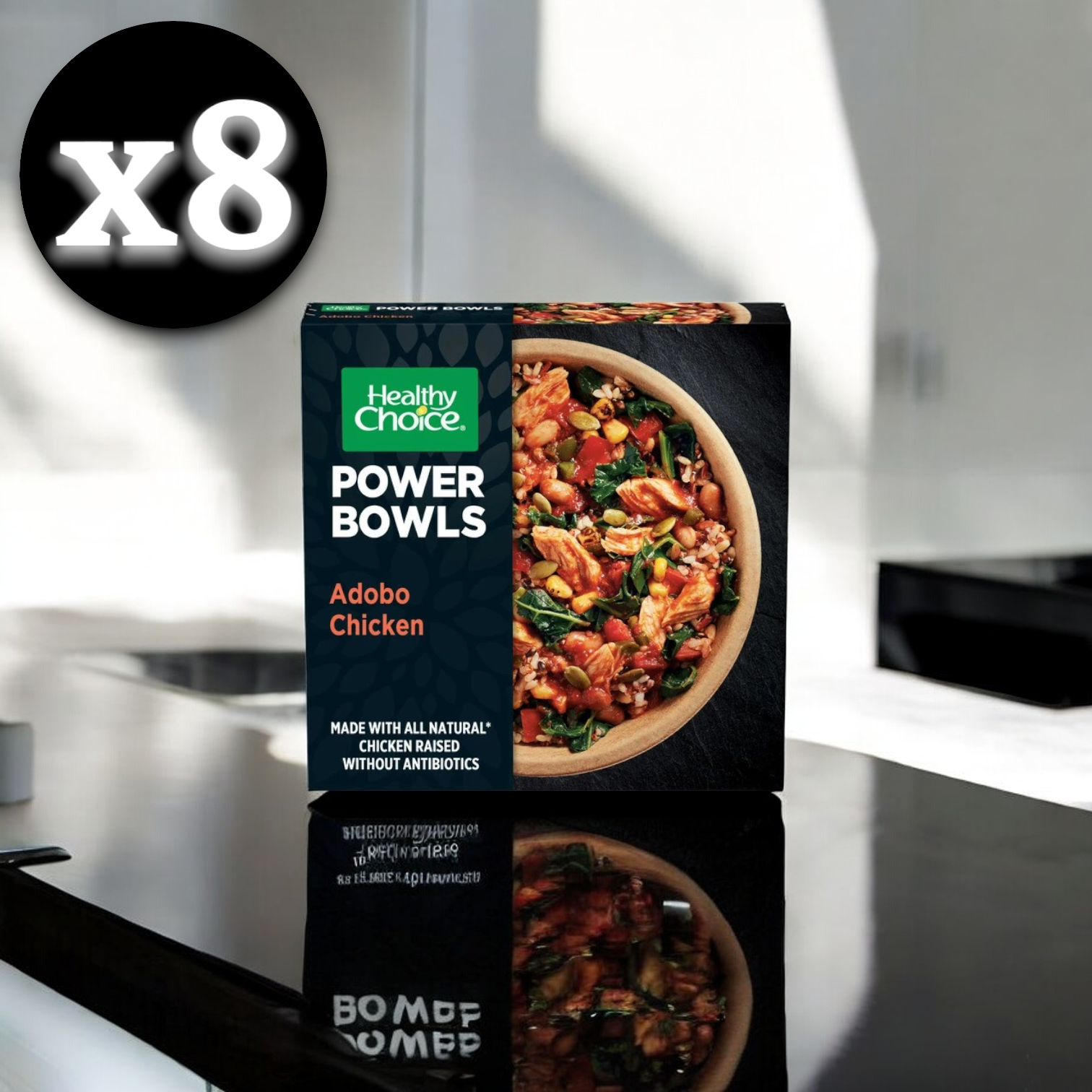 A box of Healthy Choice Power Bowls Chicken Adobo, 9.75 oz., on a kitchen counter with a shadow effect. A circle in the top left corner indicates "8 Count," suggesting a pack of eight.