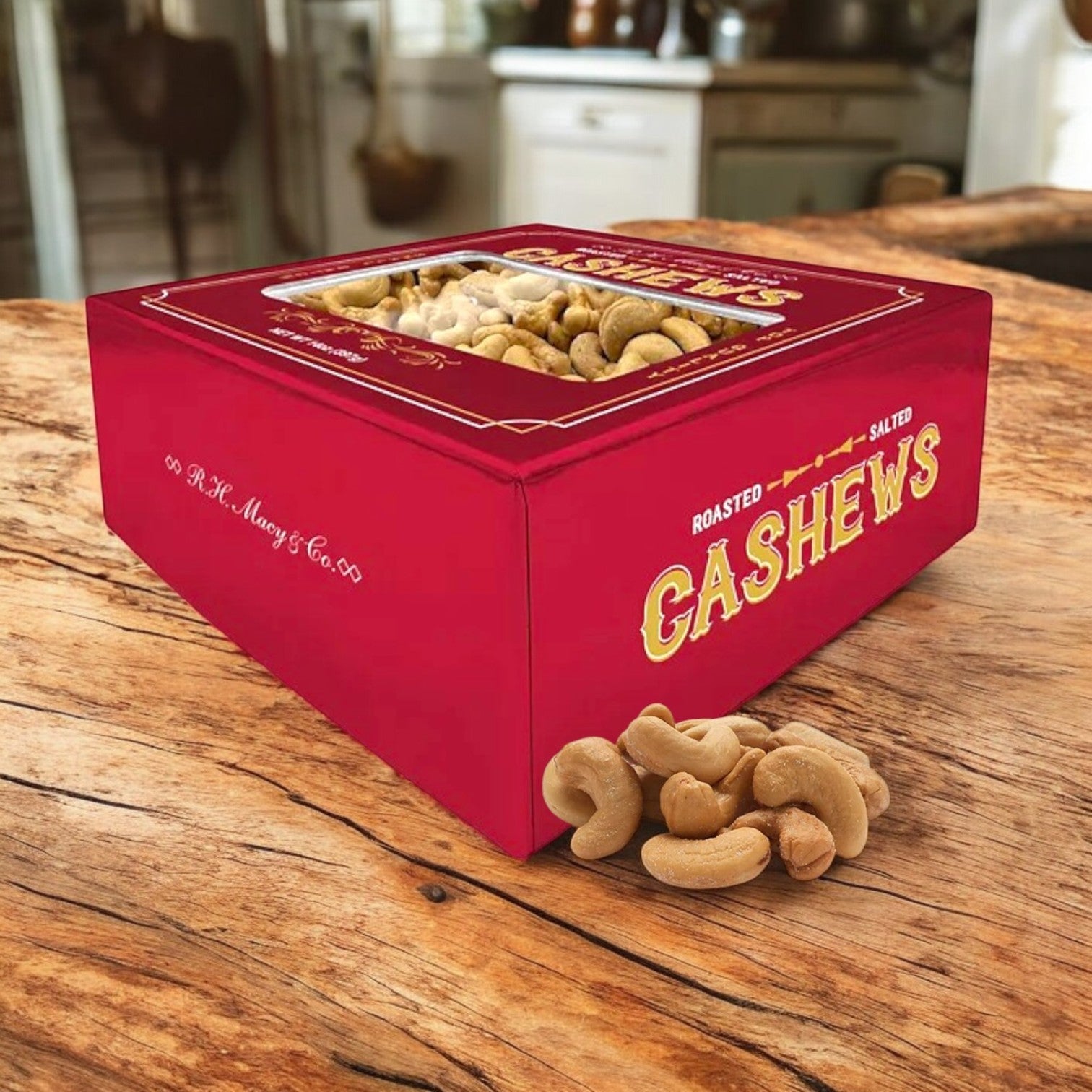 A box of Roasted Salted Jumbo Cashews Gift Box, 14 oz by Macy's sits on a wooden table with some jumbo cashews scattered in front.