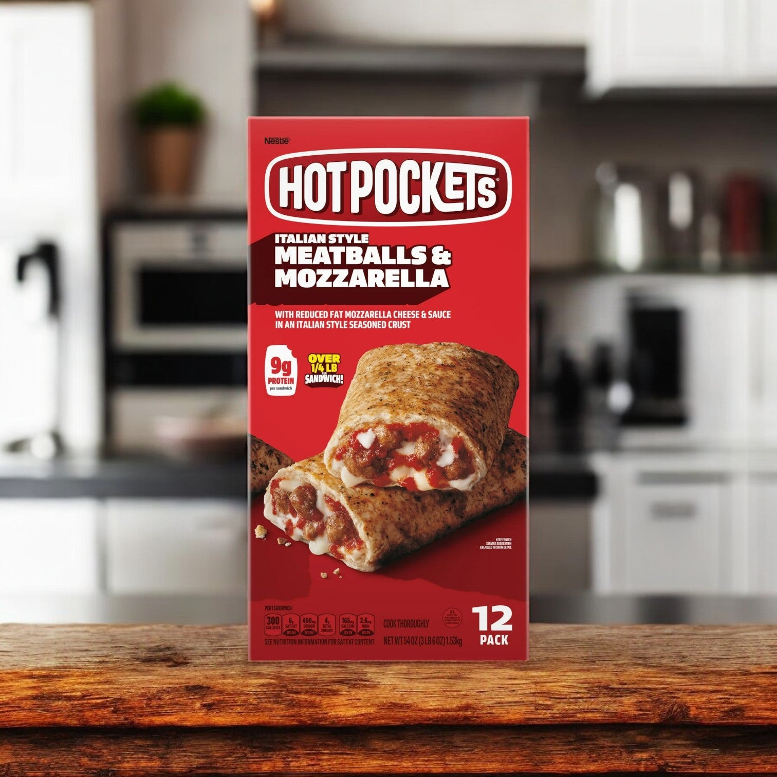 A variety pack of Hot Pockets sits on a kitchen counter. The packaging indicates a total of 36 Hot Pockets, comprising Italian Style Meatballs & Mozzarella, Pepperoni Pizza, and Ham & Cheddar Croissant Crust flavors—ideal for those seeking convenient frozen snacks. The kitchen background is blurry.