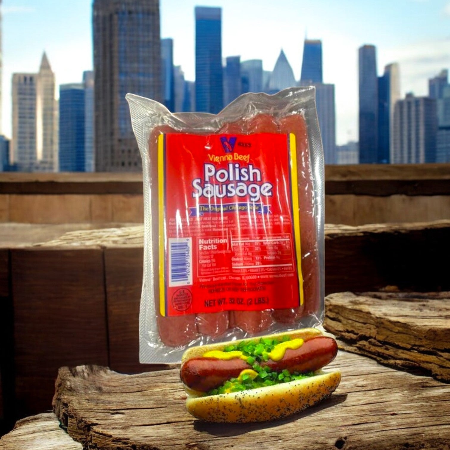 A 32 oz package of Vienna Beef Polish Sausage stands upright on a wooden surface, while a hot dog with green relish and mustard enhances the scene against the backdrop of a city skyline.