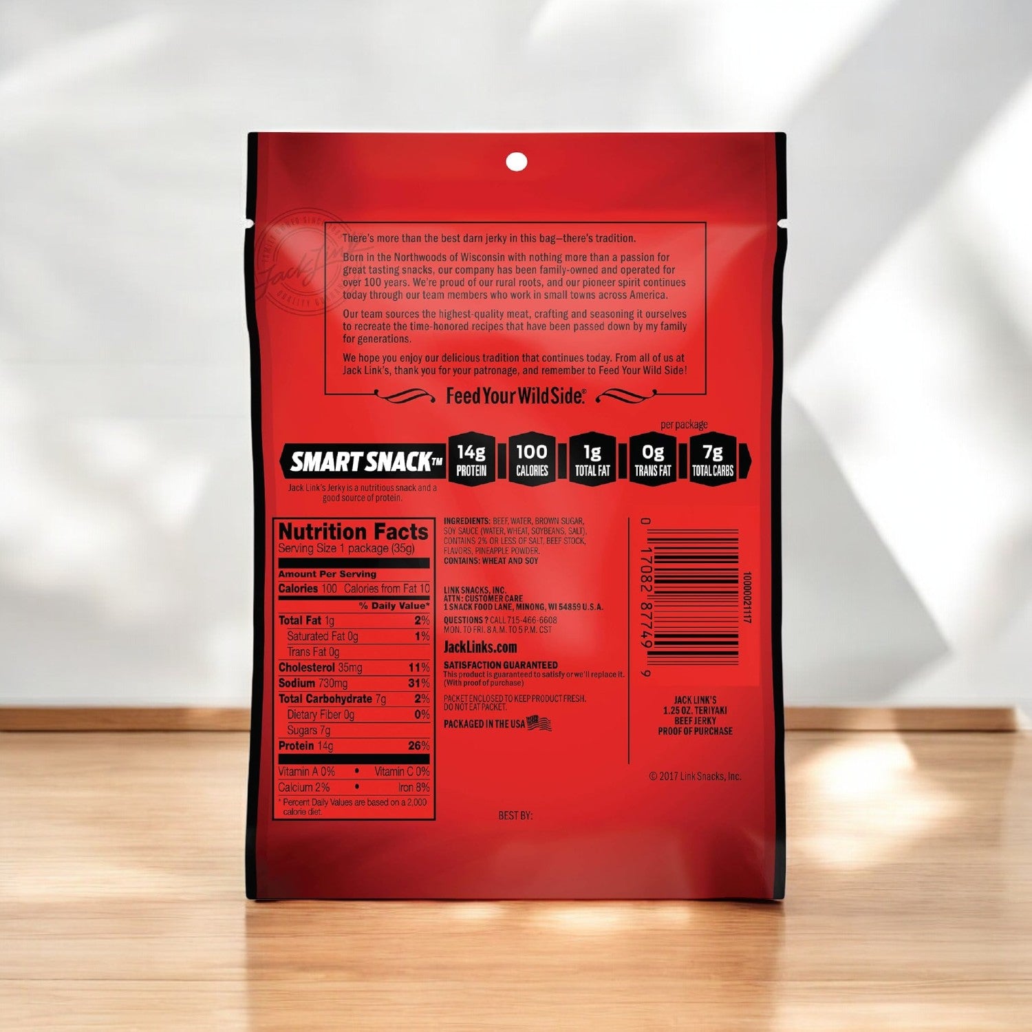 A bag of Jack Link's Beef Jerky, Teriyaki flavor (1.25 oz), showing the back side with nutritional facts and product information, placed on a wooden surface with a soft shadow in the background. Ideal for fans of meat snacks who enjoy convenient single-serve packages.