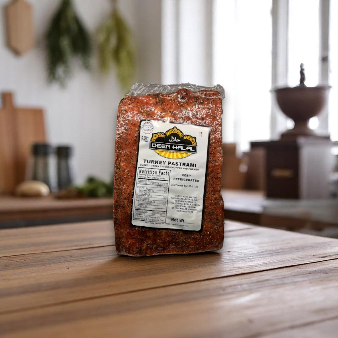 A sealed 4.0 lb Deen Halal Turkey Pastrami Slab from Deen Halal, made with halal-certified ingredients, stands upright on a wooden table in a kitchen setting.