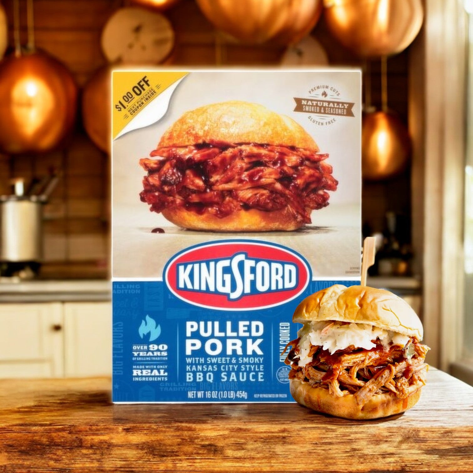 A 16 oz box of Kingsford Pulled Pork with Sweet & Smoky Kansas City Style BBQ Sauce is on the counter beside a pulled pork sandwich.