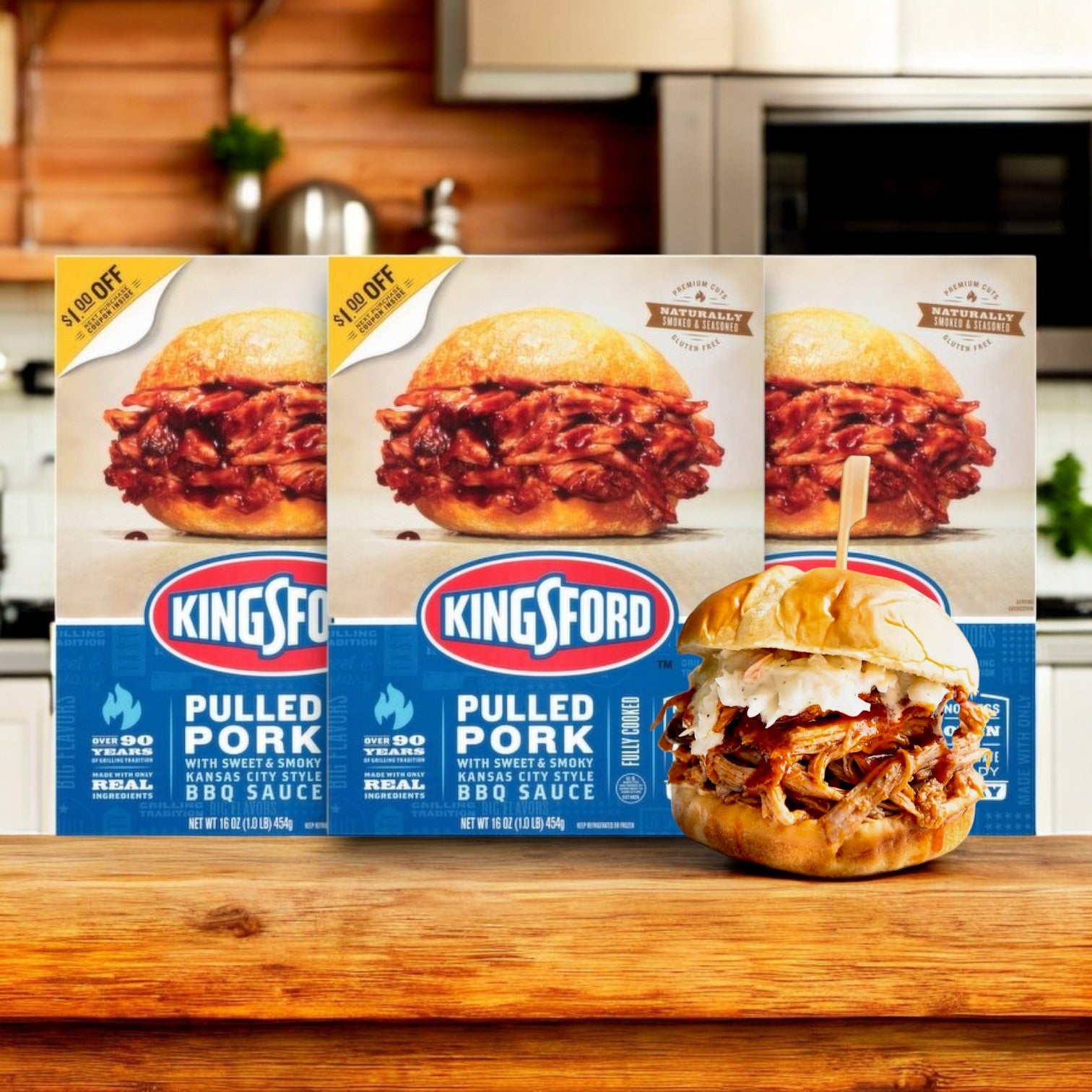 Boxes of Kingsford Pulled Pork with Sweet & Smoky Kansas City Style BBQ Sauce (16 oz., 3 Count) sit beside a sandwich filled with tender pulled pork on a wooden surface in a cozy kitchen setting.