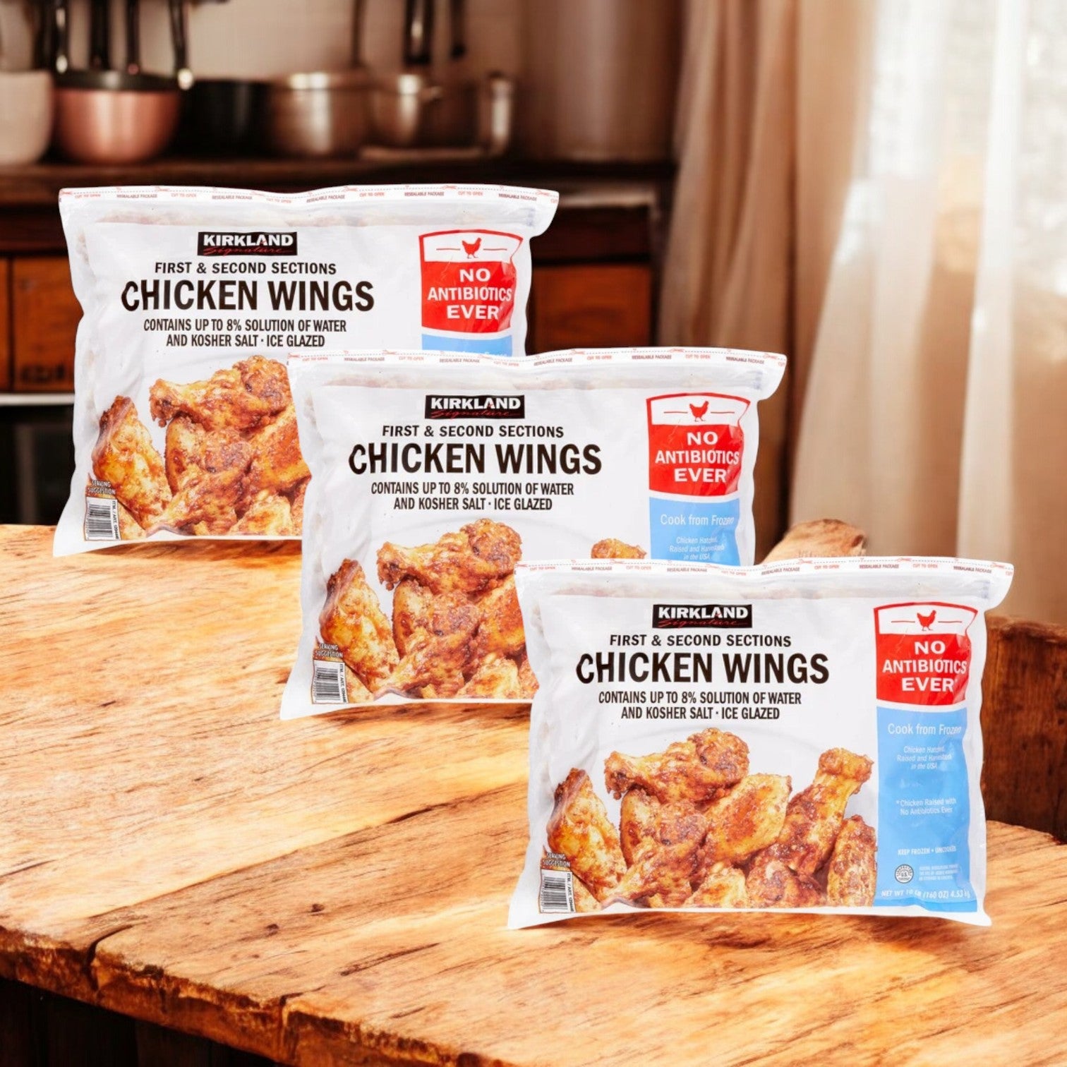 Three 10-lb. bags of Kirkland Signature Chicken Wings, totaling 30 pounds and labeled "No Antibiotics Ever," are displayed on a wooden surface, highlighting their quality and versatility.