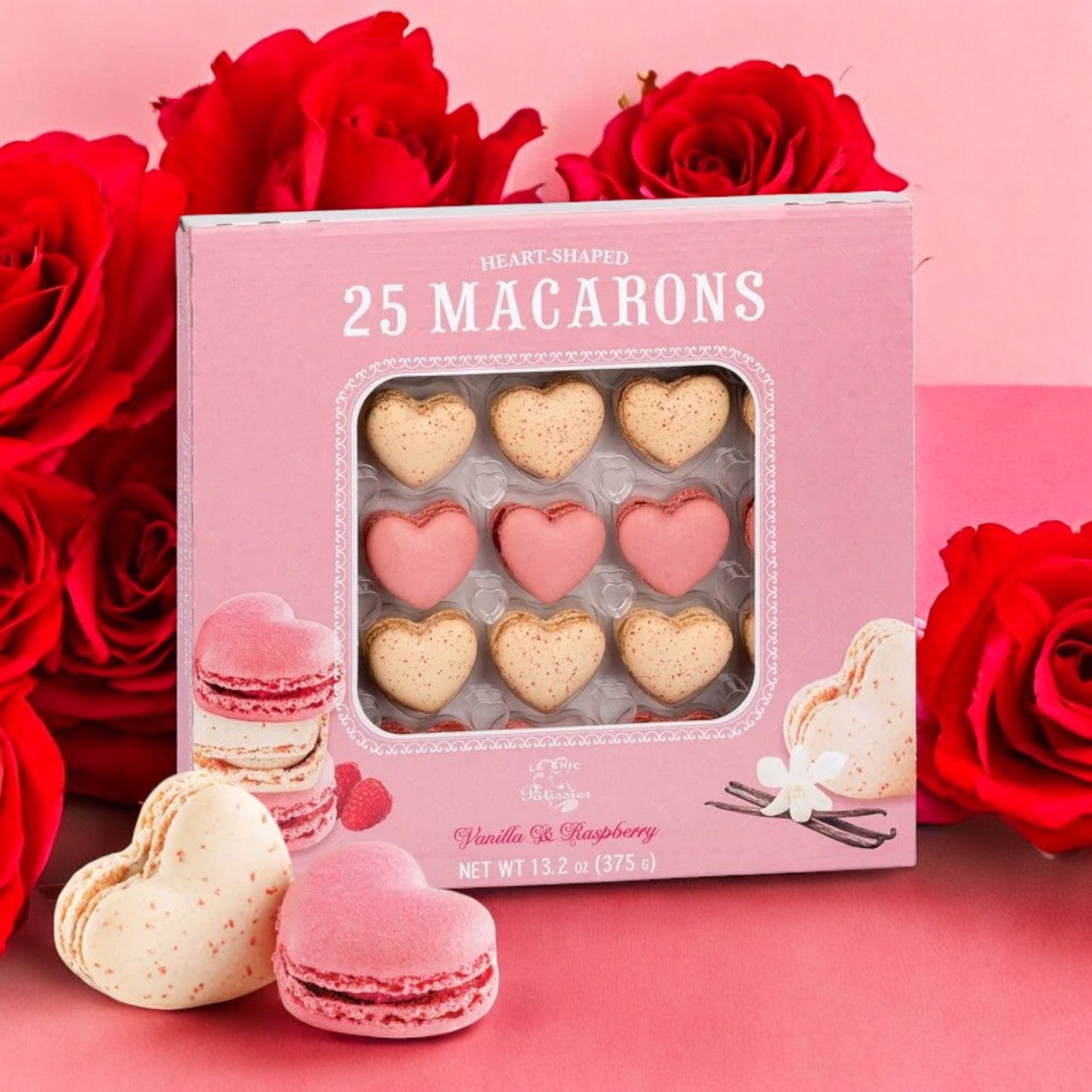 The Le Chic Patissier Heart Macaron, a 25-count box weighing 13.2 oz., features vanilla and raspberry flavors with a rose display. Its pink packaging, decorated elegantly, highlights the premium quality of this delightful treat.