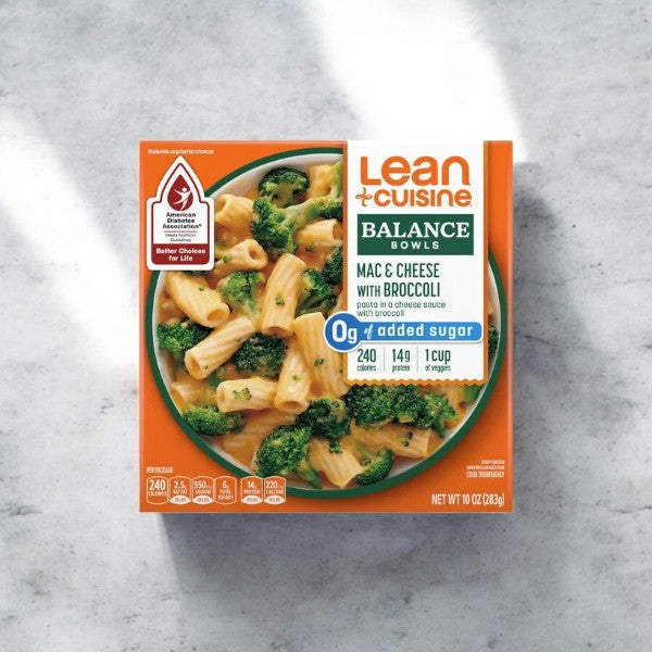 A Lean Cuisine Macaroni And Cheese With Broccoli Bowl, 10 oz., neatly placed on a marble surface. The microwaveable meal box showcases 0g added sugar, 240 calories per serving, and features the Better Choices for Life logo. Pair this convenient meal with Lean Cuisine's Chicken Fettuccini in creamy Alfredo sauce for a delightful dining experience.