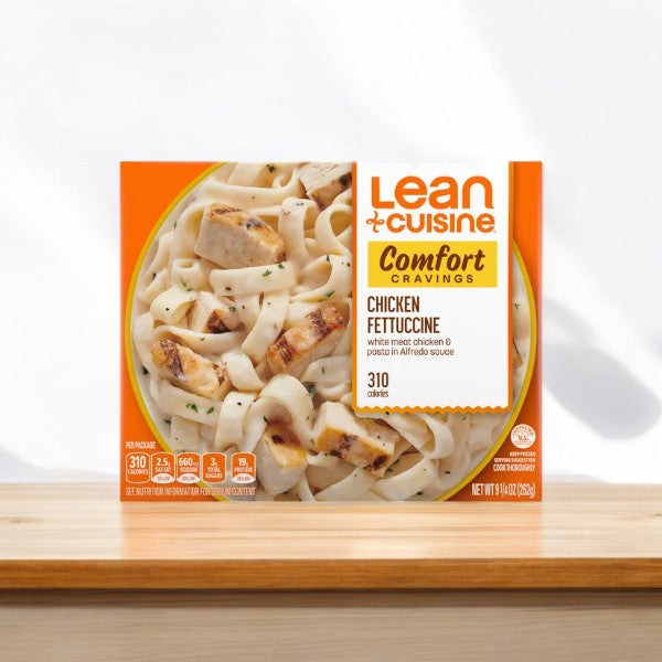 A Lean Cuisine Favorites Chicken Fettuccini meal with 310 calories, featuring grilled white meat chicken and pasta in alfredo sauce, displayed on a table against a plain background, evokes the savory convenience of their Chicken Teriyaki Bowl.