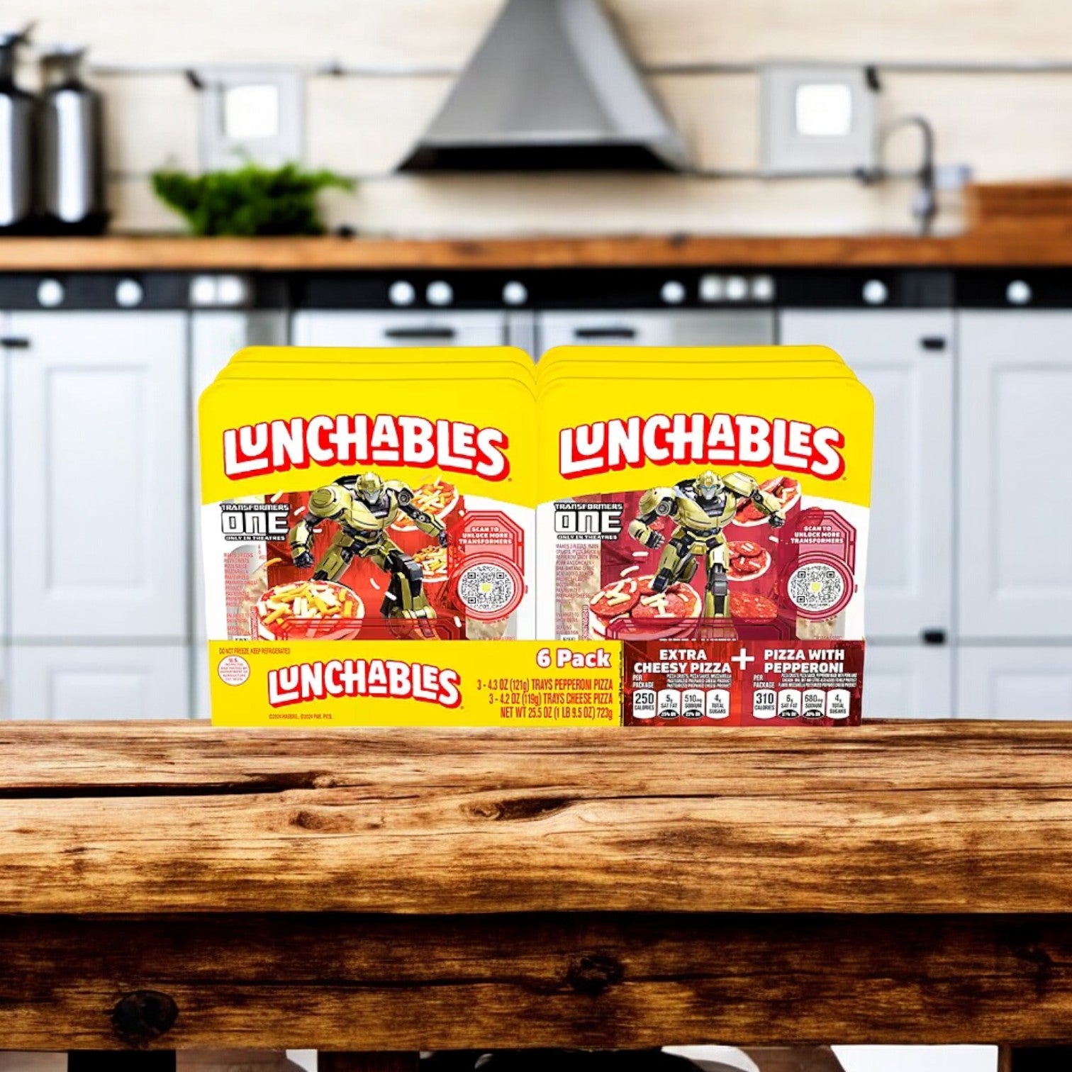 Two boxes of Lunchables Pizza Kits Variety Pack 6 pk. are displayed on a wooden table in a kitchen setting. These Lunchables kits, perfect for creating mini pizzas, feature pepperoni options and colorful packaging. A kitchen countertop and cabinets are in the background, making these ideal on-the-go snacks for busy days.