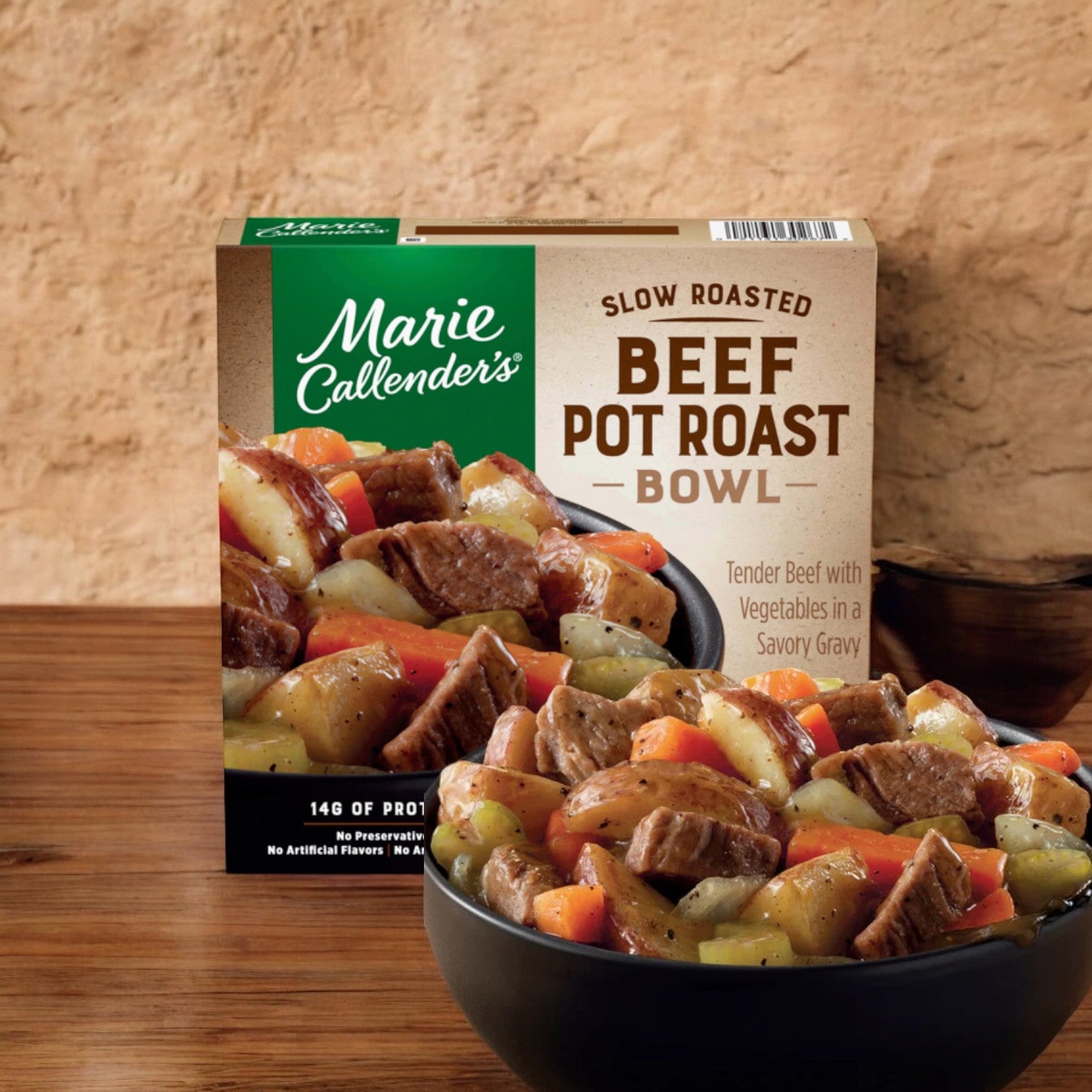 A box of Marie Callender's Slow Roasted Beef Pot Roast Bowl, 11 oz. - 1 Count is displayed alongside a serving in a black bowl, showcasing beef, potatoes, and vegetables in savory gravy.