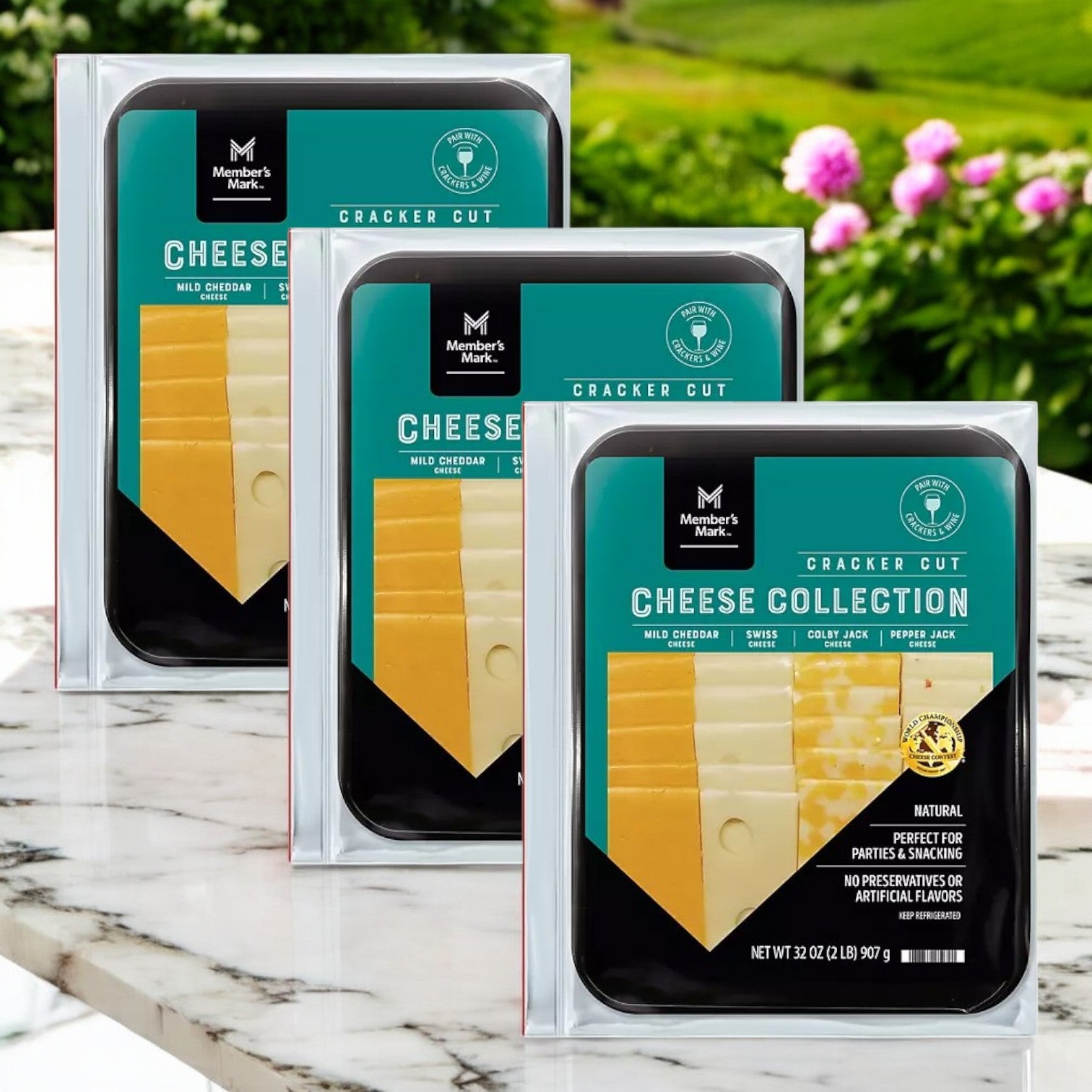 The Member's Mark Cracker Cut Cheese Variety Tray, 2 lbs. - 3 Count includes mild cheddar, Colby Jack, and pepper jack slices. Perfect for entertaining outdoors, it offers a delightful cheese display on a marble surface to impress guests.