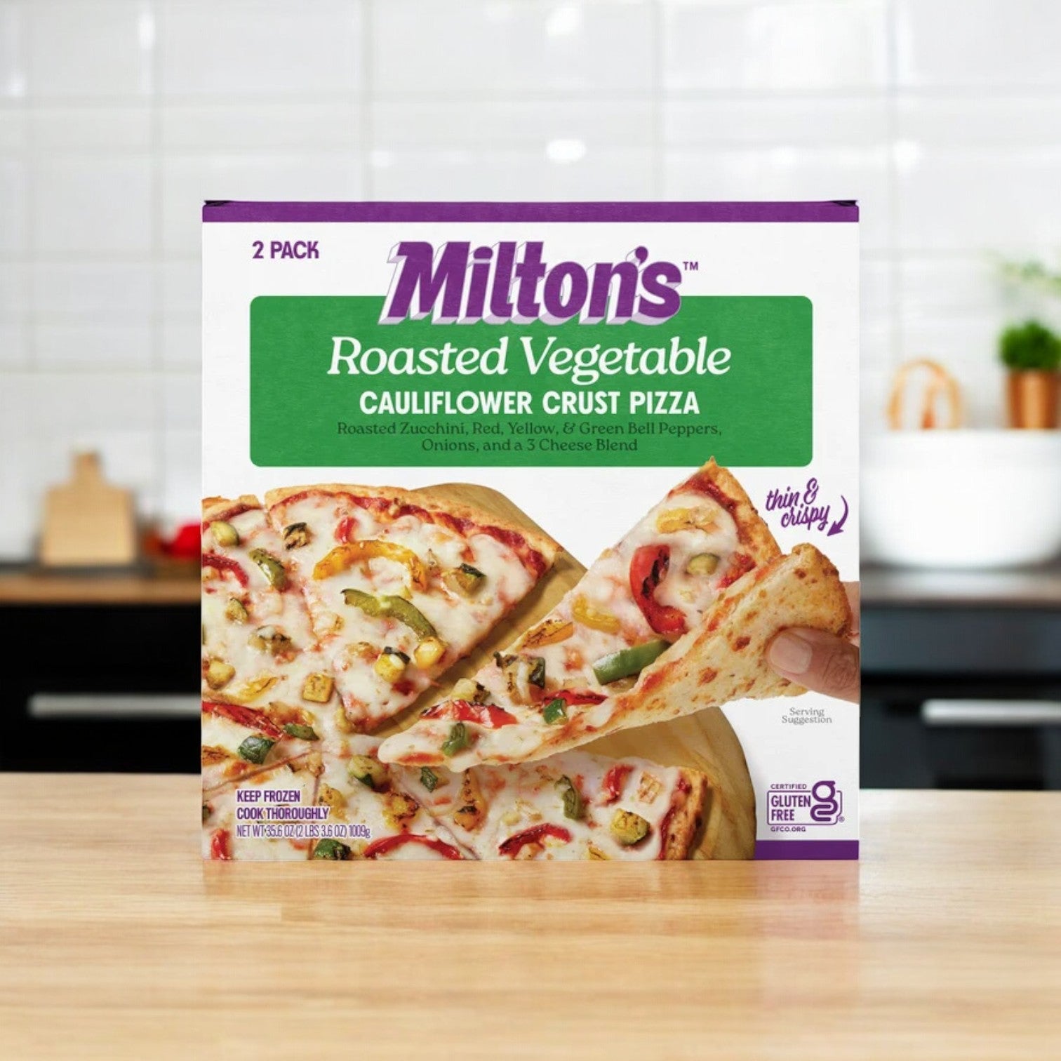 A package of Milton's Cauliflower Crust Pizza, Roasted Vegetable flavor, is placed invitingly on the kitchen counter.