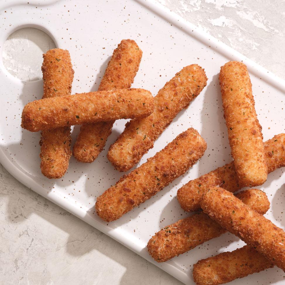 Feel Good Foods Mozzarella Sticks arranged on a white cutting board make for the perfect appetizer.