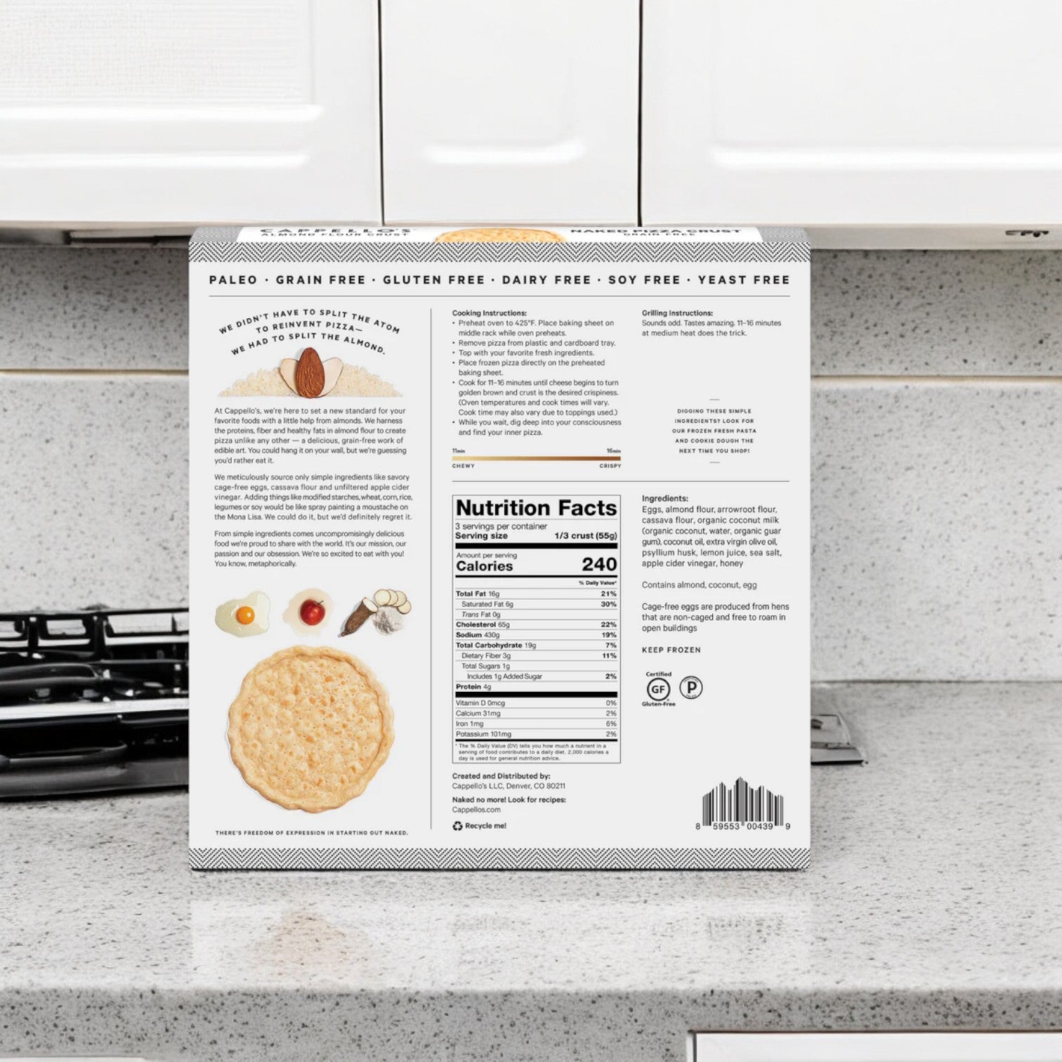 A box of Cappello's Grain Free Naked Pizza Crust sits prominently on the kitchen counter, highlighting its nutritional facts and ingredients along with various diet labels. The packaging includes suggestions for ideal toppings to pair with this crust or a gluten-free pizza, perfect for complementing your healthy lifestyle.