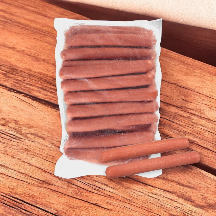 A sealed plastic packet of Nathan's Famous Frankfurter All-Beef 7" sausages rests on a wooden surface, with two hot dogs placed outside.