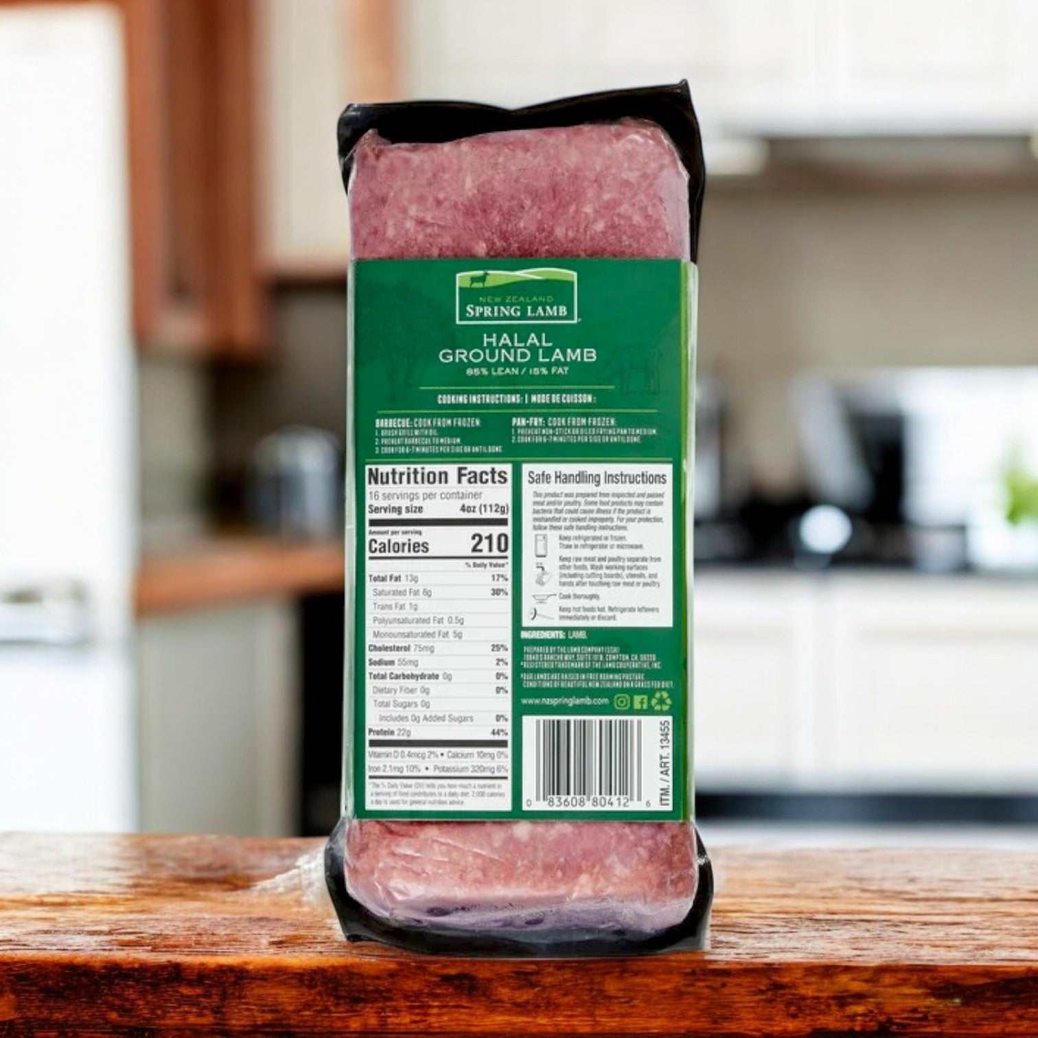 A 4 lb pack of New Zealand Spring Lamb Halal Ground Lamb, 85% lean, sits on a wooden kitchen counter with a nutritional label.