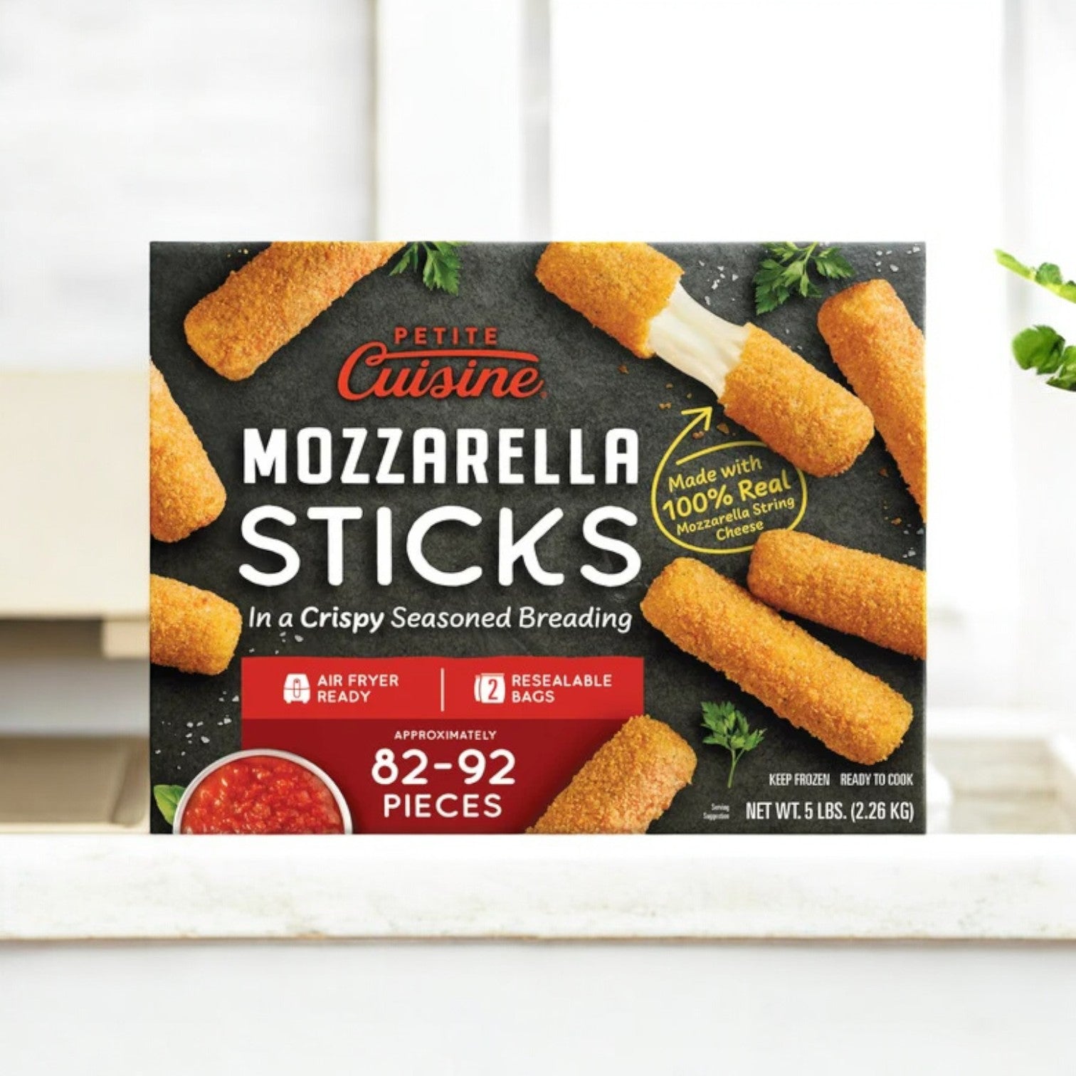 The Easy Lunches Petite Cuisine Mozzarella Sticks come in a 5 lb. box with 82-92 pieces, featuring crispy seasoned breading. Made with real mozzarella cheese, these sticks are air fryer ready and packaged in reclosable bags.