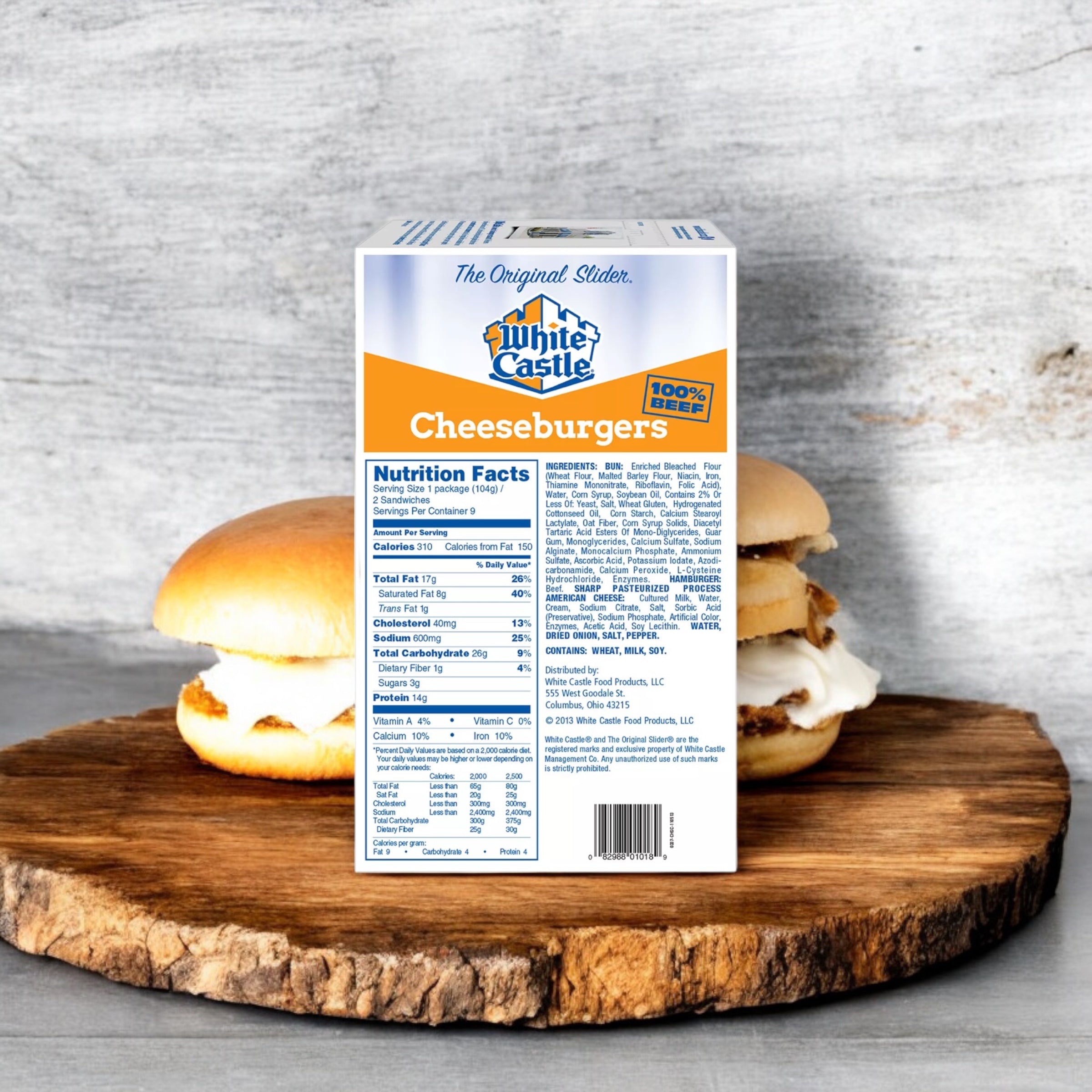 A box of White Castle Cheeseburger Sliders from Easy Lunches, containing 18 cheeseburger sliders, is displayed in front of two cheeseburgers on a wooden surface. The package shows the nutrition facts and ingredients.