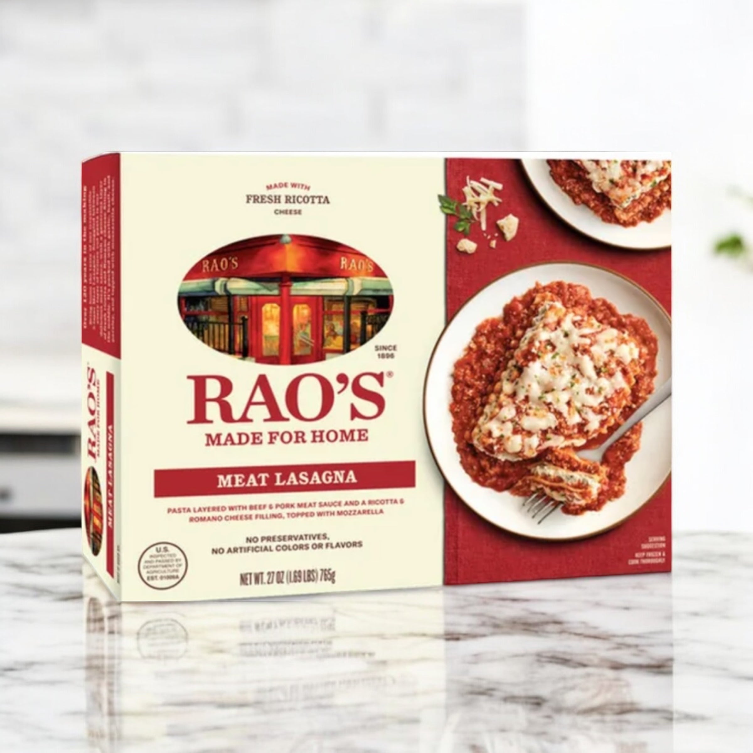 A box of Rao’s Meat Lasagna, 27 oz, from Easy Lunches displayed on a marble surface. The packaging showcases an image of lasagna, along with branding details and a description of the ingredients.