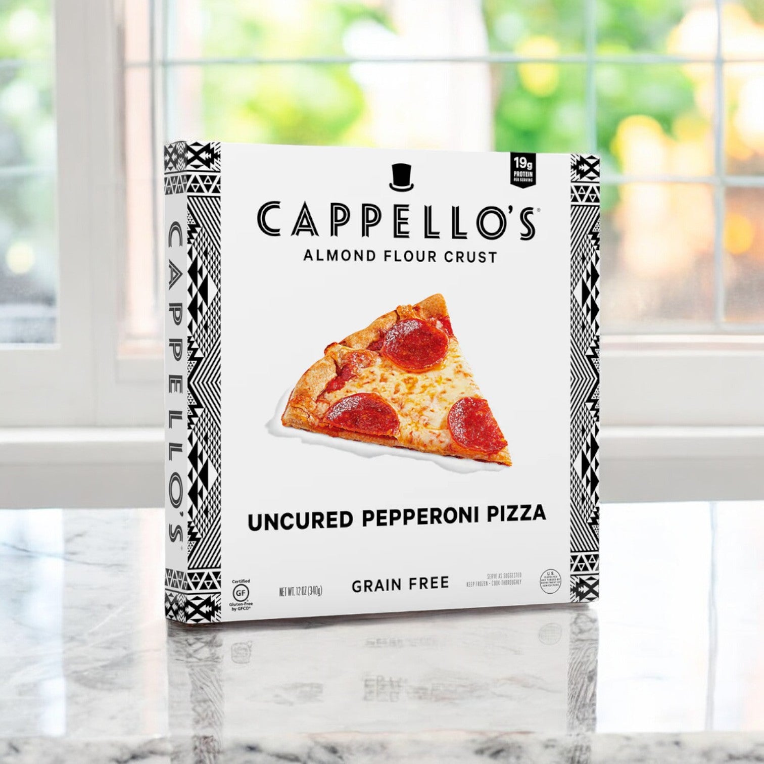 Cappello's Uncured Pepperoni Pizza, 12 oz-1Count, showcasing flavorful uncured pepperoni on a crispy almond flour crust, is displayed on a marble counter as sunlight filters through the window—an embodiment of premium ingredients and artisanal craftsmanship.