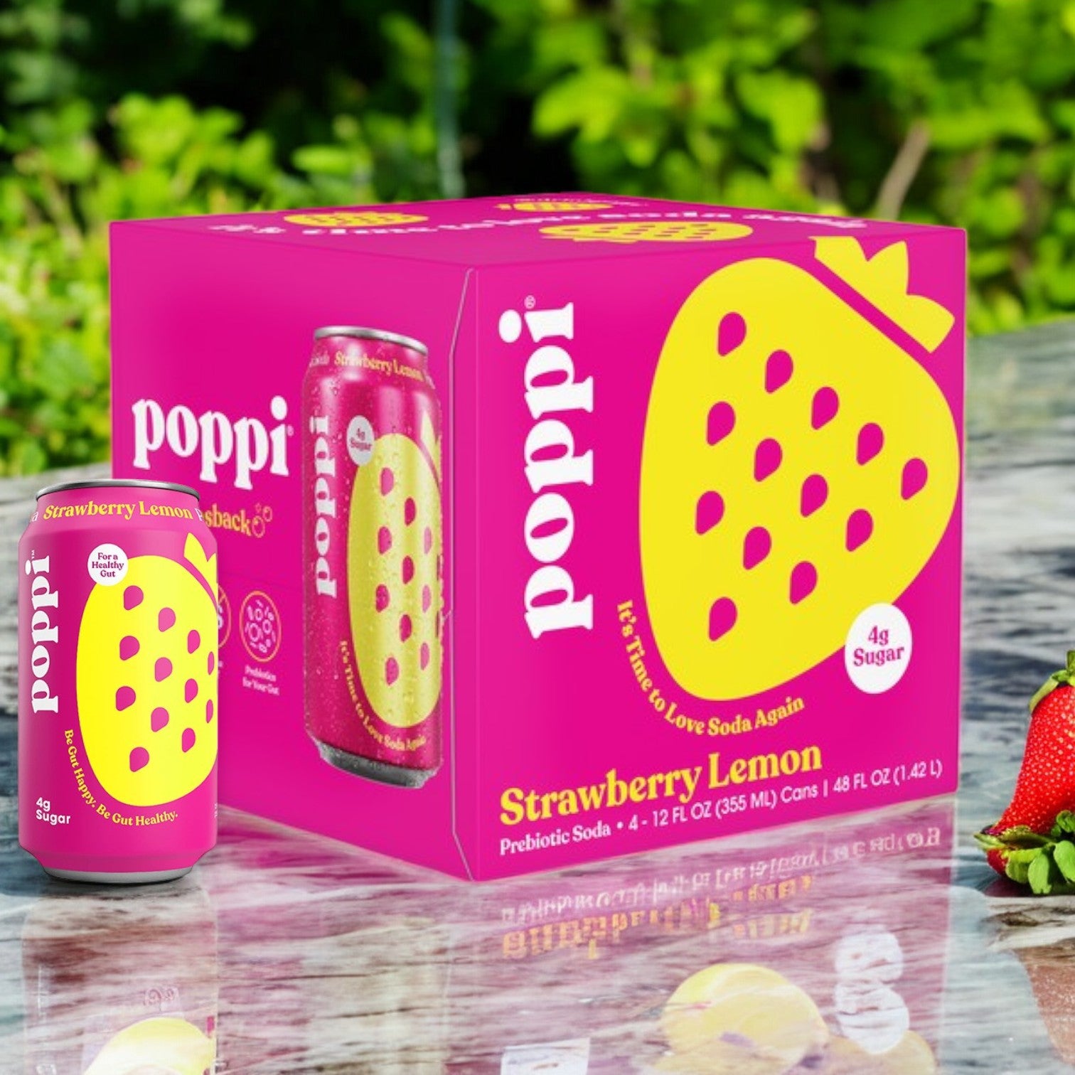 A 4-pack box of Poppi Prebiotic Soda in Strawberry Lemon sits outdoors on a reflective surface with a can beside it. The bright pink design, showcasing the Poppi brand name and strawberry icon, captures attention under the sun's glow.