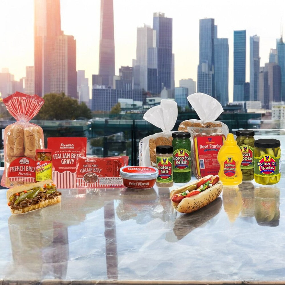 A variety of Easy Lunches packaged foods, including the Portillo's 8 Italian Beef Combo & Vienna 16 Pack Hot Dog Kit, are displayed on a glass surface with a Chicago-style city skyline in the background.