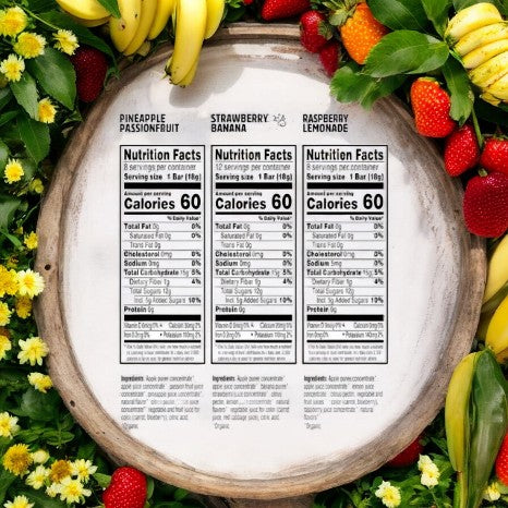 A Pure Organic 28 Layered Fruit Bars Variety Pack, featuring nutrition facts for Pineapple Passionfruit, Strawberry Banana, and Raspberry Lemonade bars, is beautifully displayed on a circular wooden platter surrounded by bananas, strawberries, and flowers. These wholesome snacks made with organic fruit are perfect for a nutritious treat.