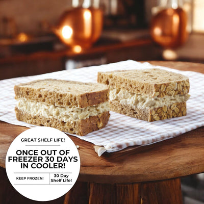 Two Ranch Chicken Salad Sandwiches on multigrain bread, laid on a checkered cloth. Text: "Once out of freezer, 30 days in cooler. Keep frozen. 30-day shelf life." Brand: E.A. Sween