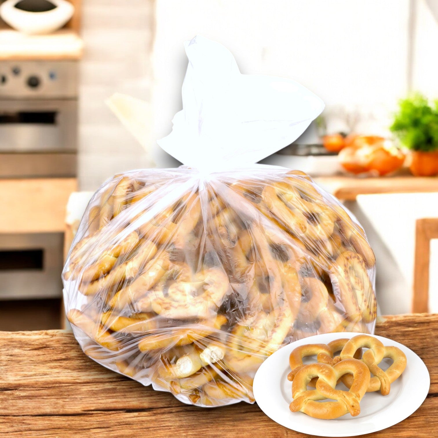 A large plastic bag of SUPERPRETZEL Soft Baked Pretzels (100 Count, 2.5 oz each) sits on a wooden kitchen surface, while a small plate with a few soft baked treats is in the foreground.