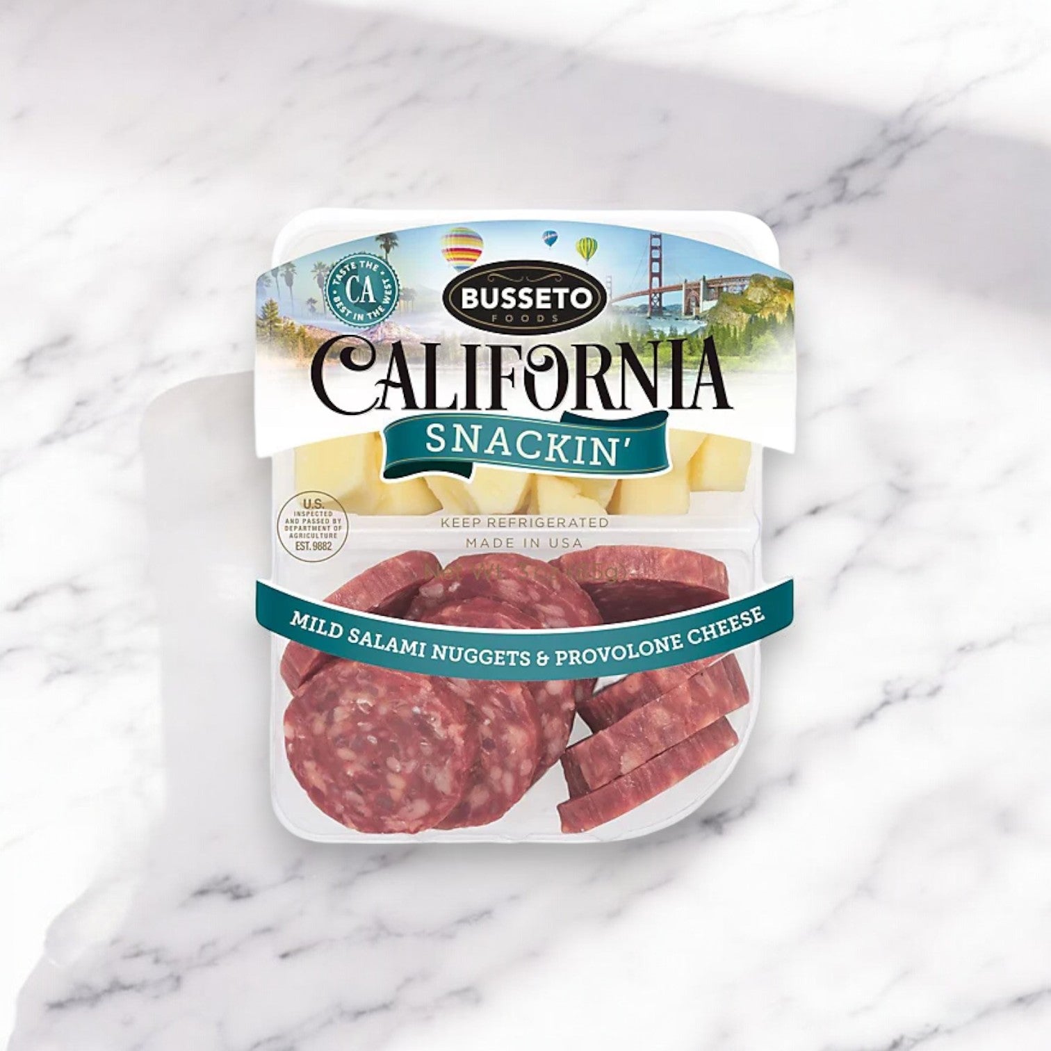 Busseto's 3 oz. Salami Dry And Provolone Snackin, placed on a marble surface, offers a savory high-protein treat.