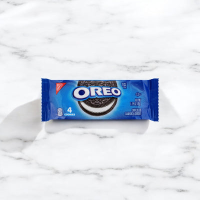 A small blue bag of Nabisco's OREO Chocolate Sandwich Cookies, containing four chocolate wafers with a white creme filling, is placed on a white marble surface.