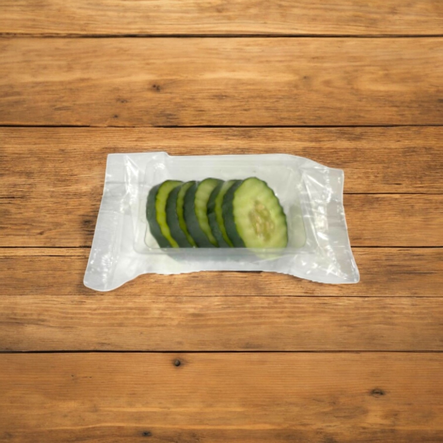 Easy Lunches' Made-to-Order Sliced Cucumber (2.5 oz, 100 count) in clear packaging sits on a wooden surface, offering a refreshing snack perfect for healthy snacking with a 7-day shelf life.