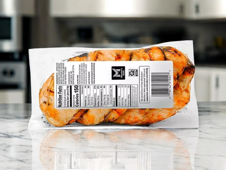 Member's Mark Fire Grilled Chicken Breasts, Fresh 6 ct-1 Pack by Easy Lunches sits on a marble countertop with nutrition details visible, making it a convenient meal option. The blurred kitchen background highlights this protein-packed choice.