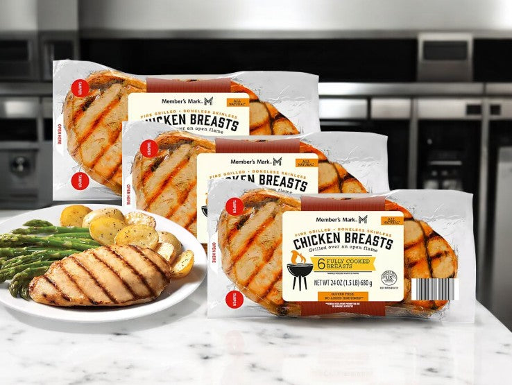 Packages of Easy Lunches' Member's Mark Fire Grilled Chicken Breasts, Fresh 6 ct - 3 Pack are on a kitchen counter with a plate showcasing grilled chicken, potatoes, and asparagus for a convenient meal option.