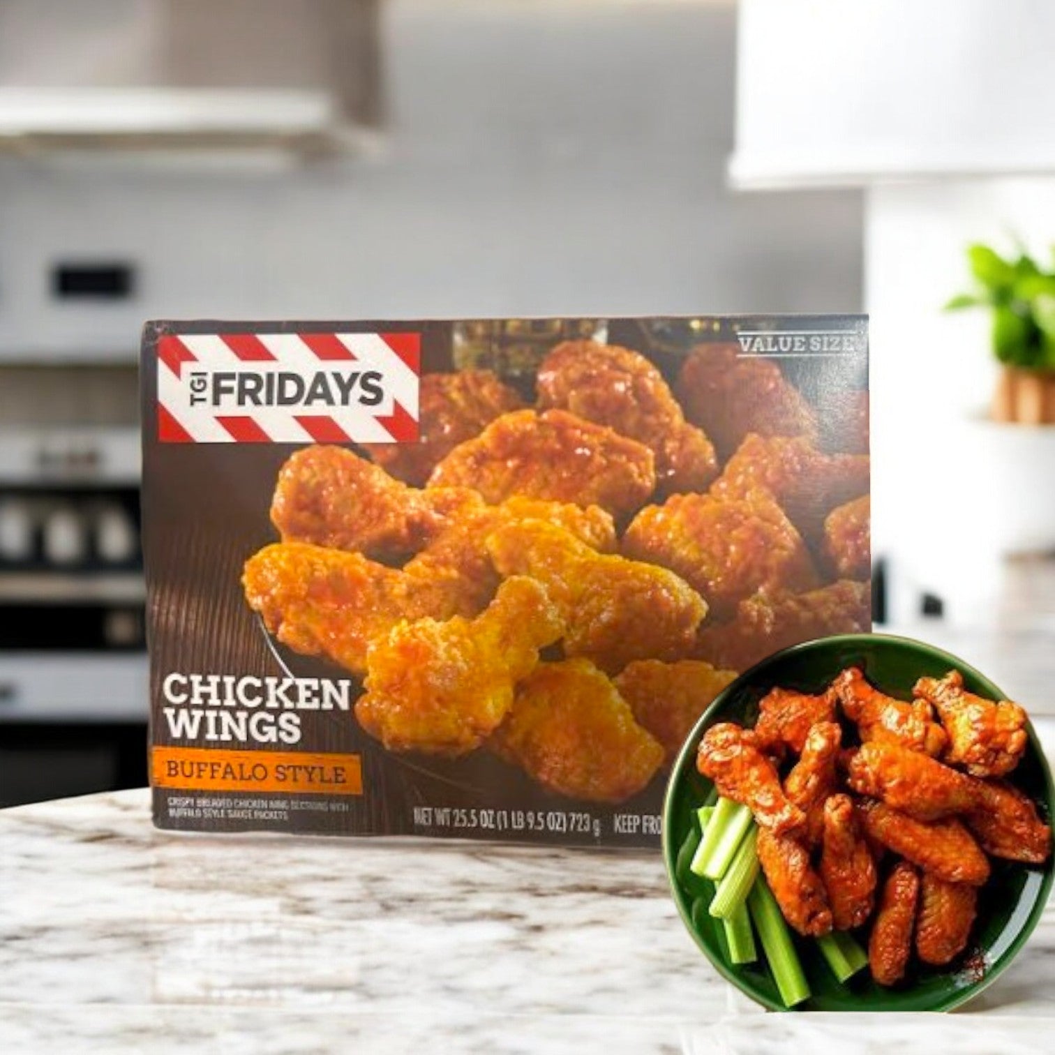 A TGIF Fridays Buffalo Style Chicken Wings box sits on the kitchen counter, promising an ultimate wing experience. An inset image shows cooked wings dressed in tangy buffalo sauce with crisp celery sticks in a bowl.