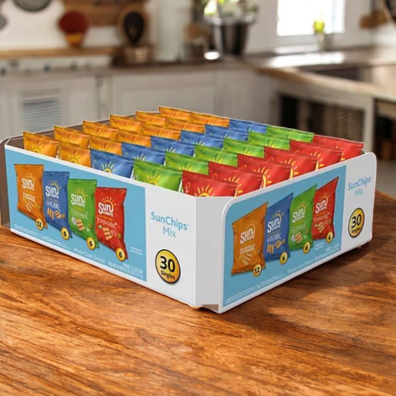 A box of SunChips Variety Pack Whole Grain Chips, featuring 30 bags in Harvest Cheddar, Garden Salsa, Original, and French Onion flavors, elegantly presented on a wooden kitchen table.